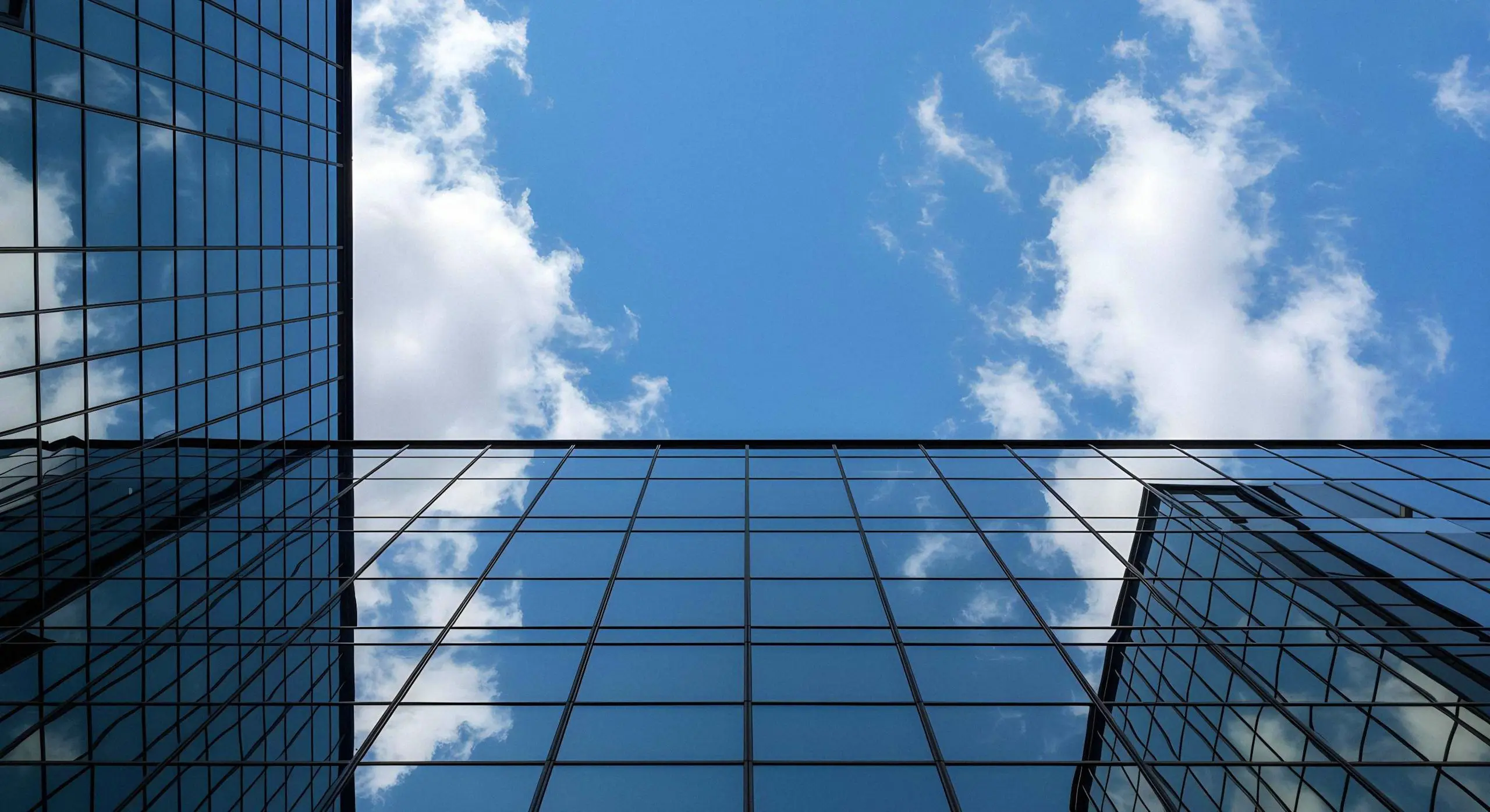skyscraper reflecting sky clouds